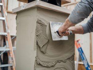 Używanie kielni do tynkowania komina